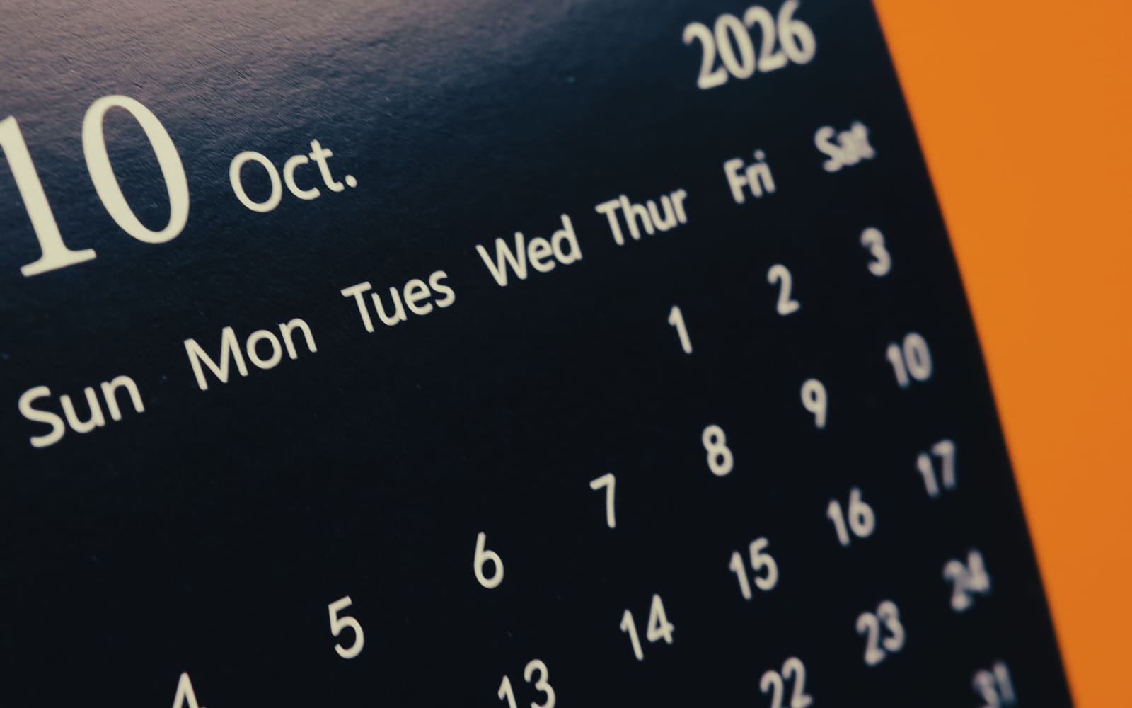 The dates of an October desk calendar page, seen at an angle
